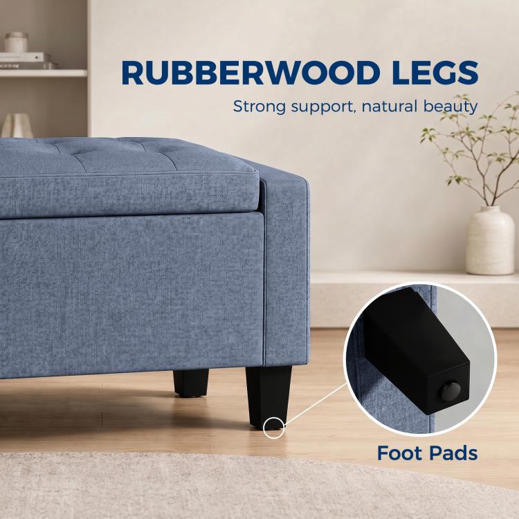 Dark blue-gray storage ottoman with rubberwood legs and protective foot pads