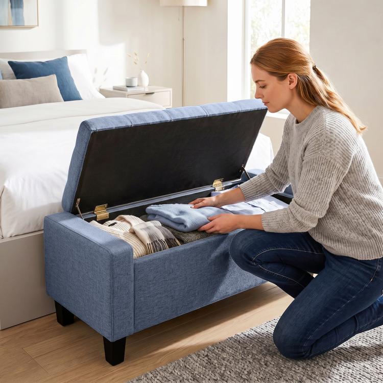 Dark blue-gray storage ottoman bench with open hinged lid for hidden storage