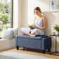 Dark blue-gray cushioned storage ottoman bench with wooden legs and side arm panels