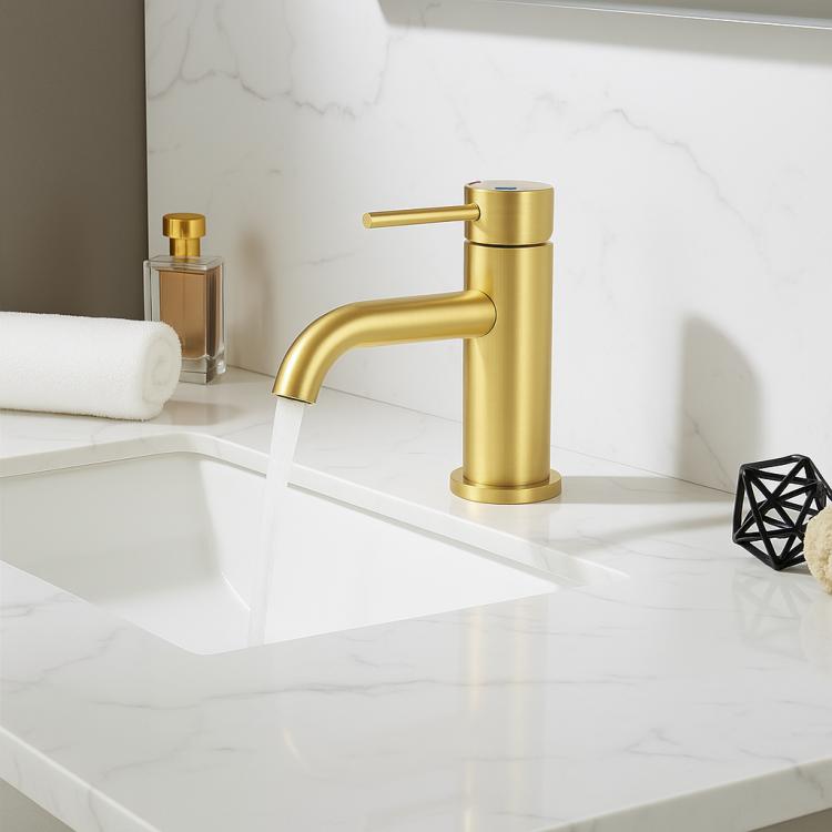 Brushed gold single-handle lavatory faucet on countertop sink with matching spout