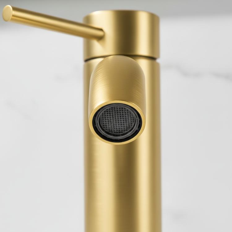 Brushed gold faucet aerator end cap detail on single-handle spout