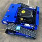 Blue remote crawler mower showing open engine bay and black rubber track treads