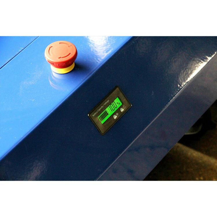 Blue mower control panel with red emergency button and green warning label
