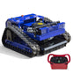Blue crawler mower with rubber tracks, side guards, and red remote controller