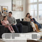 Black corduroy sectional sofa with modular chaise and multiple seat cushions