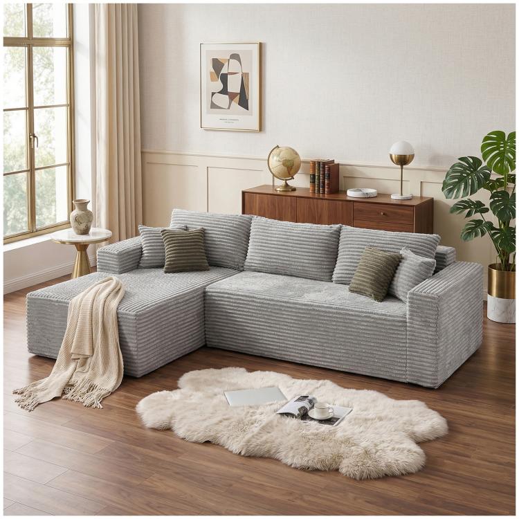 Light grey corduroy L-shaped sectional sofa with oversized chaise and throw pillows
