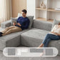 Gray corduroy modular sectional sofa with extended chaise and cushioned armrests