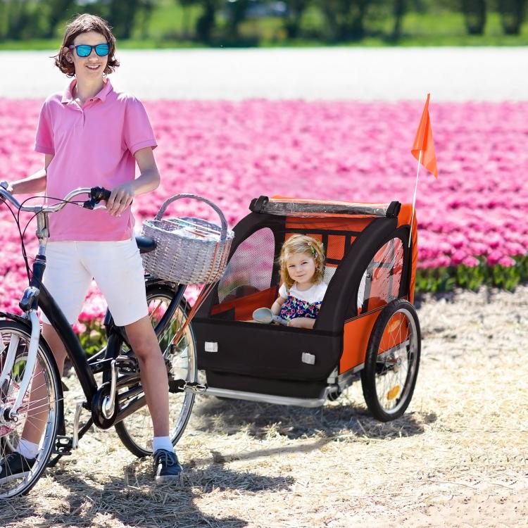 Orange and black 2-seat child bike trailer with safety flag and seated child