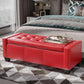 Red faux leather storage ottoman with tufted cushion top and panel-side stitching