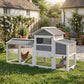 Mobile chicken coop with run, gray roof panels, and side access door in garden