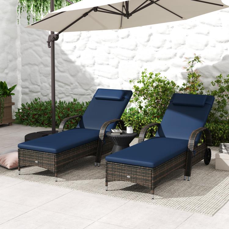 Two rolling outdoor chaise lounge chairs with blue cushions, headrests, and dark woven frames