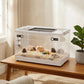 Transparent hamster cage with top vent and front doors on a wooden table