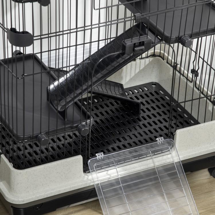 Close-up of black wire ramp and perforated tray area with clear slide-out bottom tray