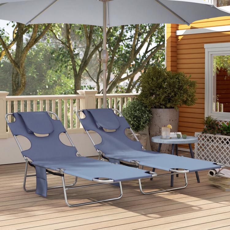 Set of two gray outdoor chaise lounges with face openings and head pillow