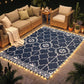 Outdoor rug on patio with warm LED strip border lighting and white geometric medallion pattern