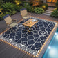 Deck patio rug with warm LED border lights and white geometric quatrefoil pattern