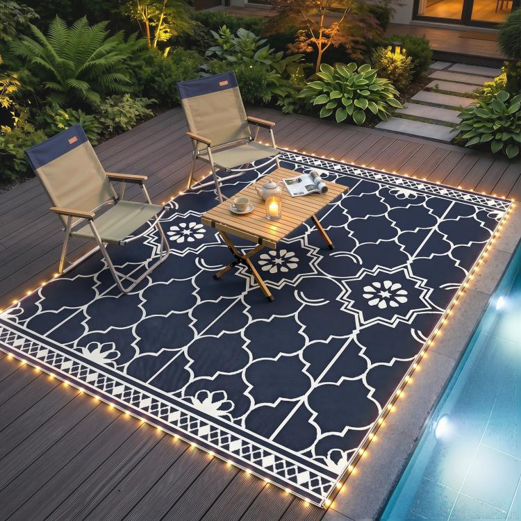 Deck patio rug with warm LED border lights and white geometric quatrefoil pattern