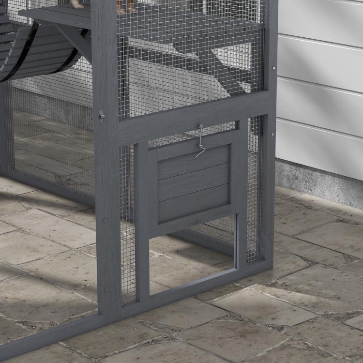 Gray wooden outdoor cat enclosure with mesh panels and hinged door front
