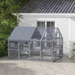 Gray outdoor cat enclosure with waterproof cover and mesh sides, shown beside a house wall