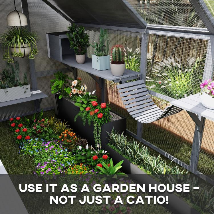 Gray cat enclosure with mesh walls, platforms, and connected lounging areas in a garden setting