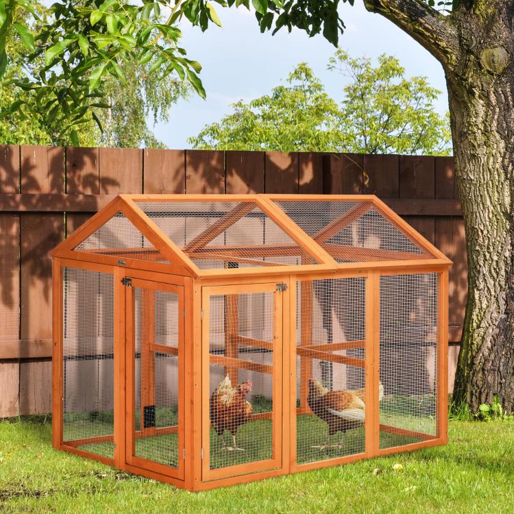 Orange wooden chicken run with wire mesh panels and pitched roof in a backyard
