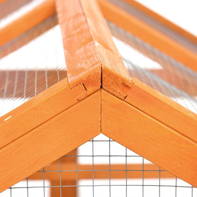 Orange wooden chicken run corner joint close-up with wire mesh roof support