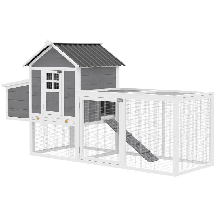 Large wooden chicken coop with gray roof, wire fronts, ramp, and nesting area