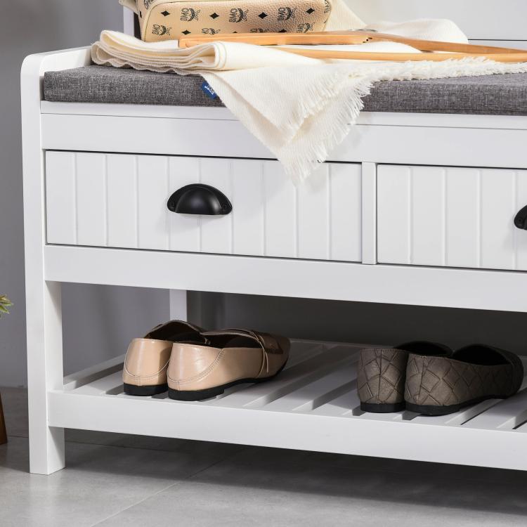 White entryway hall tree bench with padded gray seat and open shoe storage