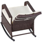 Angled view of beige-cushioned rattan rocking recliner with footrest and curved base