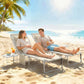 Two beige lounge chairs with adjustable backrests on the beach