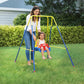 Toddler swing set with red seat and hanging ropes, with an adult holding the frame