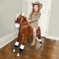 Brown plush ride-on horse with white socks and rolling wheels, shown with a child