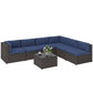 L-shaped outdoor sofa sectional with navy cushions and dark wicker coffee table