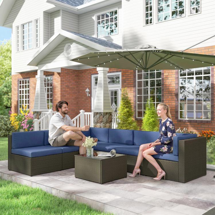 Outdoor sectional sofa set with blue cushions and glass-top coffee table, brown frame