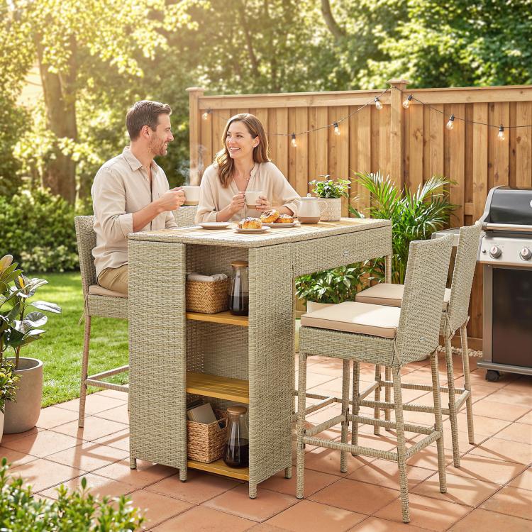 Wicker outdoor bar table with 3-tier cabinet shelves and cushioned bar stools for patio dining