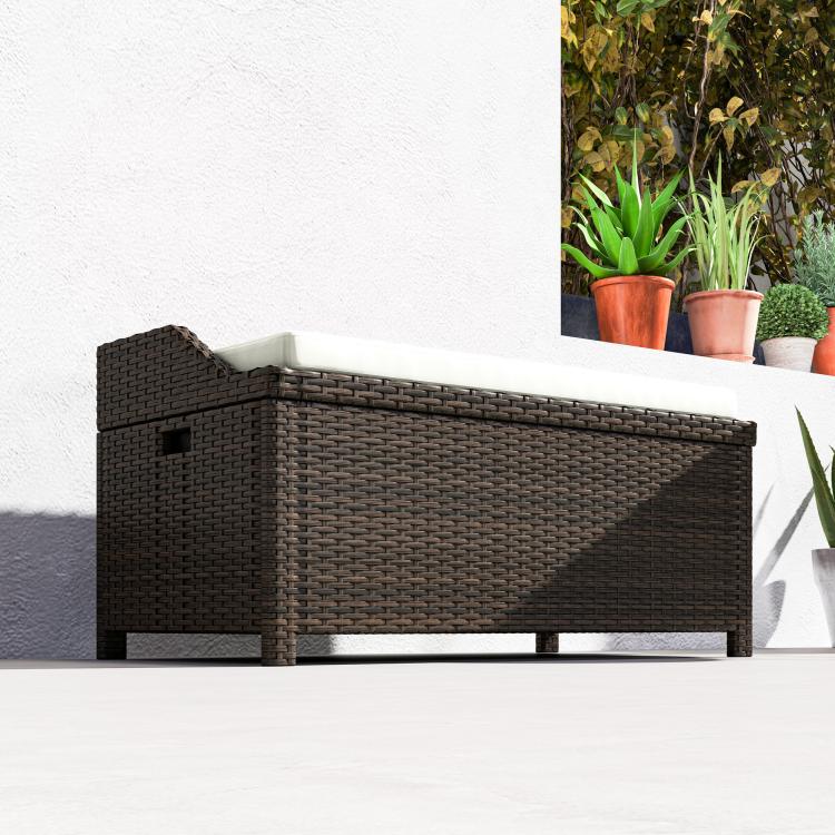 Outdoor wicker storage bench with storage and white cushion, side view