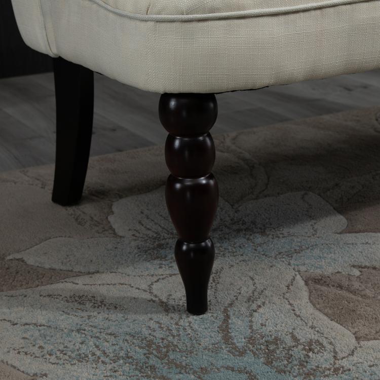Cream armless loveseat with dark turned wood legs