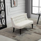 Cream button-tufted armless loveseat with dark wood legs, in a living room setting