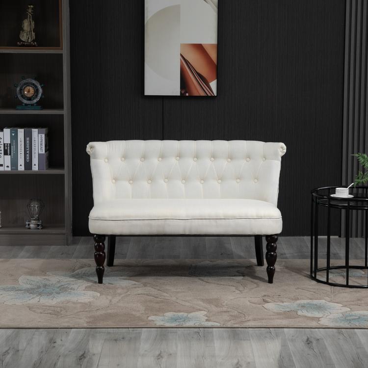 Cream armless loveseat with button-tufted backrest and dark turned wood legs