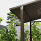 Dark metal grill gazebo hardtop roof with open sides and corner posts