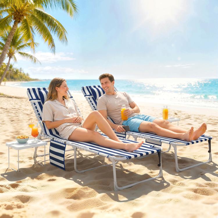 Two beach lounge chairs with blue-and-white striped fabric, metal frames, and side tables