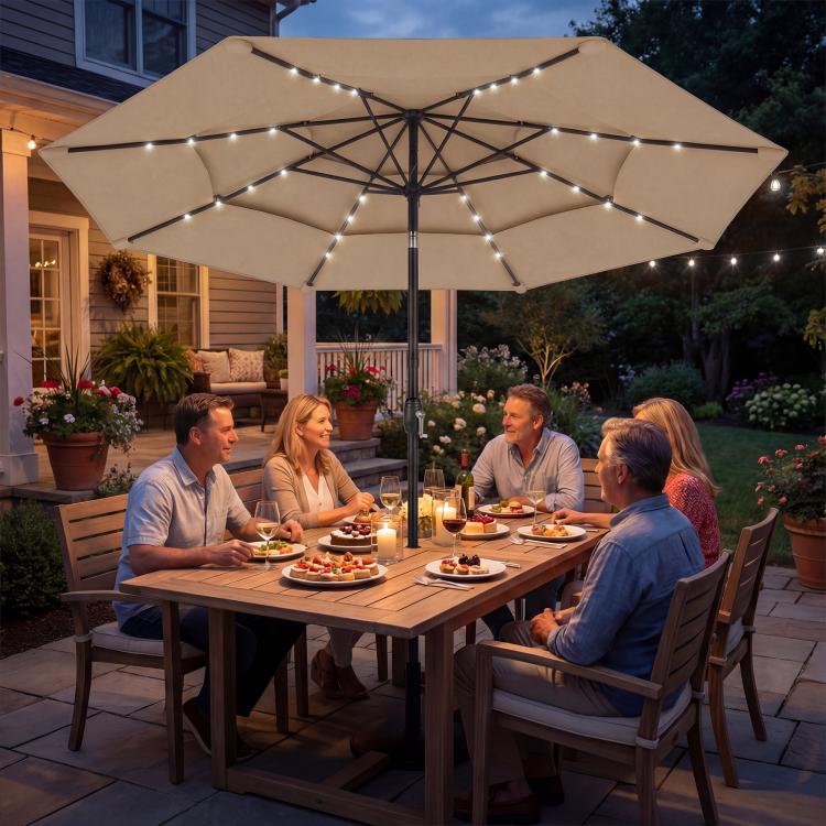 Khaki patio umbrella with three-tier canopy and glowing solar LED light strings