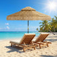Khaki thatched patio umbrella with straw fringe and black center pole, open rounded canopy