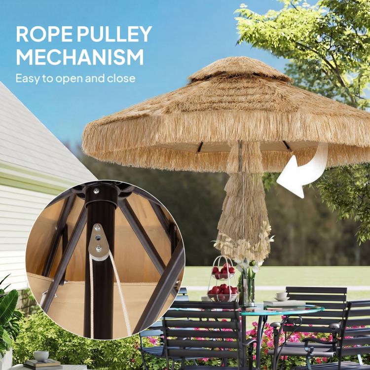 Rope pulley opening mechanism with black umbrella pole and thatched khaki canopy above