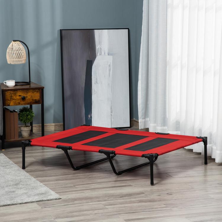 Red elevated dog bed with black mesh panels and black metal support legs