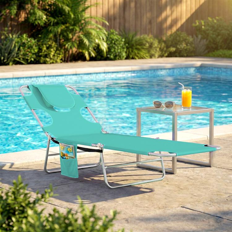 Light green outdoor chaise lounge with face hole and padded head pillow on metal legs