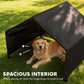 Black dog shelter tent with roomy interior, dog lying inside on grass