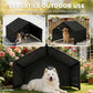 Black outdoor dog shelter tent with canopy roof and open front, dog outside on patio
