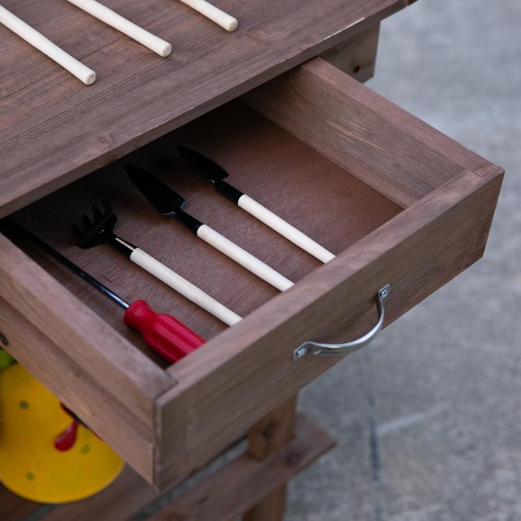 Brown wooden potting bench work table drawer open with gardening tools
