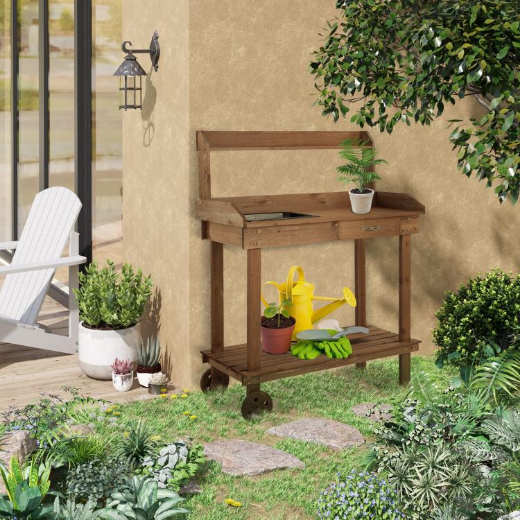 Wooden potting bench with sink opening and two-tier shelf for gardening items